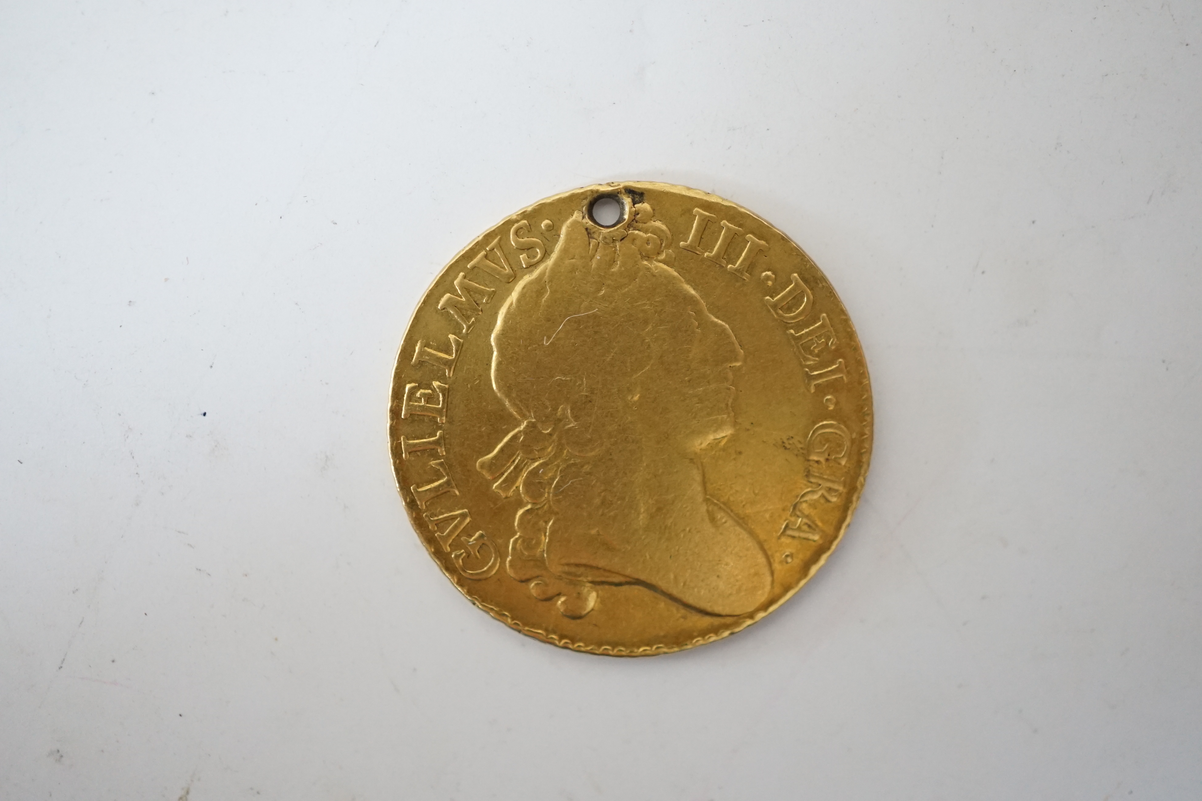 British gold coins, William III guinea, 1698, holed otherwise VG/F, 7.58g